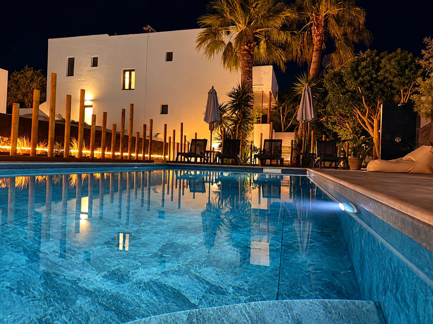 Dragonfly Villas and the pool lit up at dusk