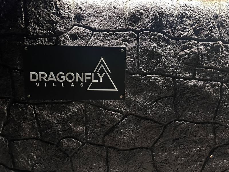 Dragonfly Villas sign on the volcanic stone wall – Dragonfly Villas, Santorini