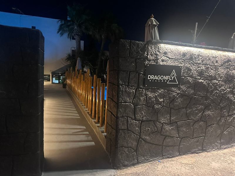 Hotel entrance with the Dragonfly Villas sign at night – Dragonfly Villas, Santorini