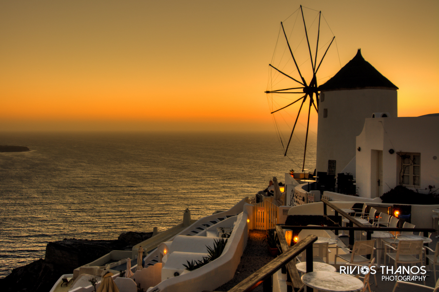 Windmill and whitewashed houses at sunset over the Aegean Sea, Santorini