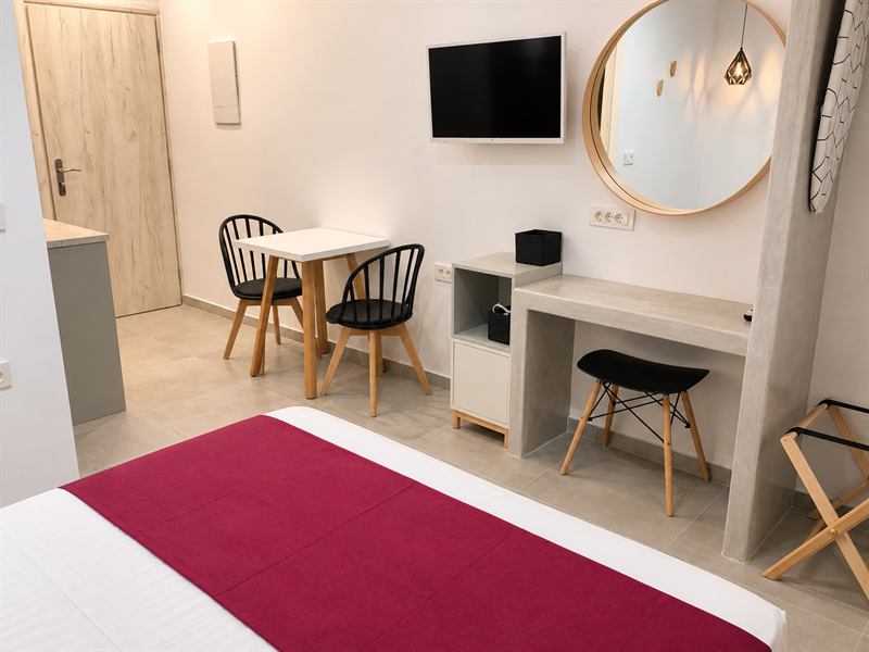 Studio Apartment – Bedroom, desk and dining table, Dragonfly Villas Santorini